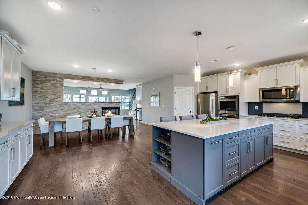 11 Lighthouse Point Road, Unit 601 Highlands, NJ 07732 - Photo 27 of 79 a large kitchen with lots of furniture a sink appliances and a dining table