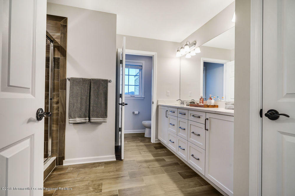11 Lighthouse Point Road, Unit 601 Highlands, NJ 07732 - Photo 39 of 79 a bathroom with a granite countertop sink mirror and shower