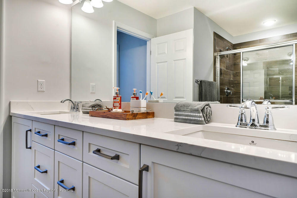 11 Lighthouse Point Road, Unit 601 Highlands, NJ 07732 - Photo 40 of 79 a bathroom with double vanity sink and a mirror