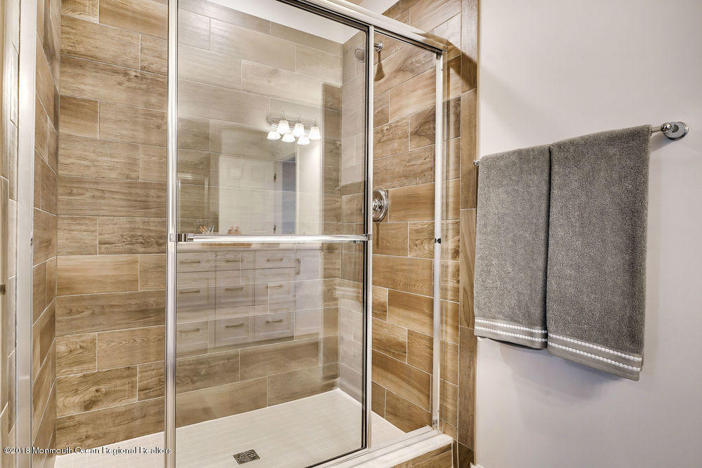 11 Lighthouse Point Road, Unit 601 Highlands, NJ 07732 - Photo 41 of 79 a bathroom with a shower and a mirror