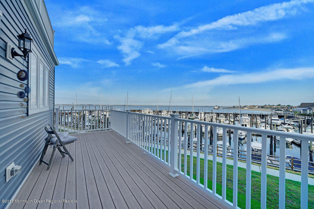 11 Lighthouse Point Road, Unit 601 Highlands, NJ 07732 - Photo 46 of 79 a balcony with wooden floor and city view
