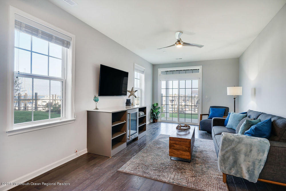 11 Lighthouse Point Road, Unit 601 Highlands, NJ 07732 - Photo 10 of 79 a living room with furniture and a flat screen tv