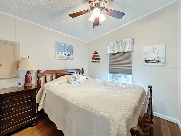 a bedroom with bed and wooden floor