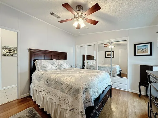 a bedroom with bed and a chandelier