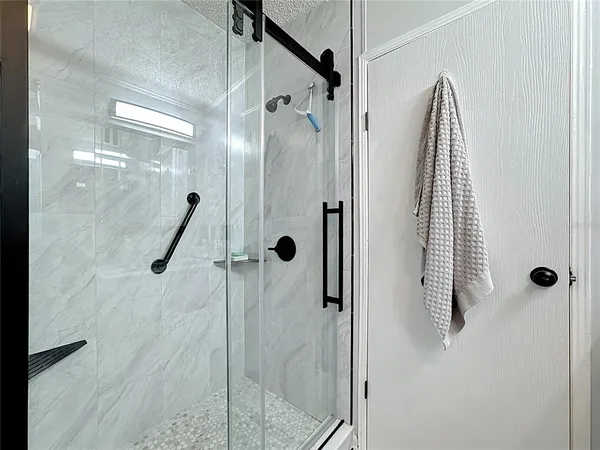 a bathroom with a shower and a sink