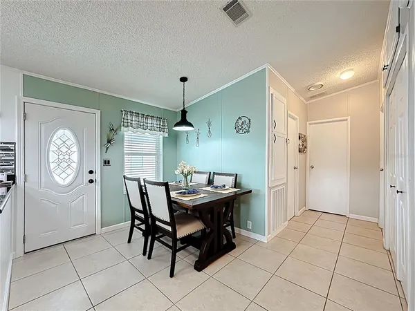 a kitchen with a table and a refrigerator
