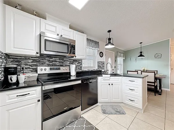 a kitchen with cabinets stainless steel appliances and a sink