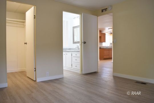 1345 Dunes Street Ridgecrest, CA 93555 - Photo 14 of 31 an empty room with wooden floor and windows