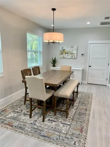 a view of a dining room with furniture window and wooden floor