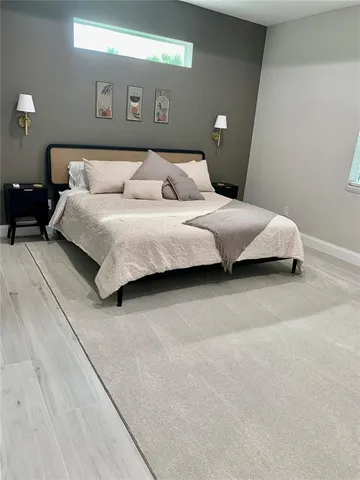 a bedroom with a bed and a night stand