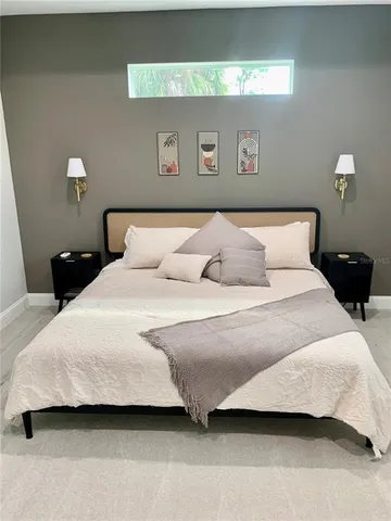 a bedroom with a bed and a night stand