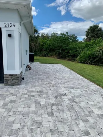 a view of a porch with a table and chairs