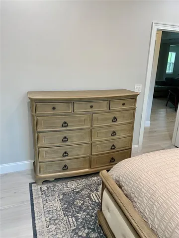 a bedroom with furniture and wooden floor
