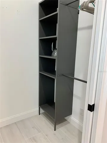 a bedroom with two beds and painting on the wall