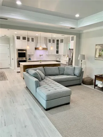 a living room with furniture and kitchen view