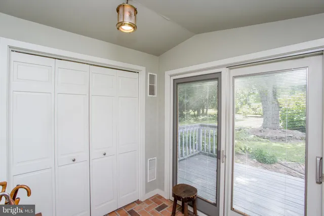 a living room with furniture a wooden floor and next to a window