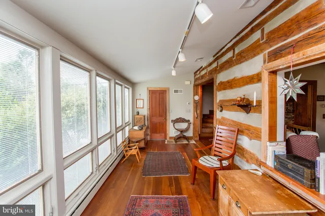 a dining room with wooden floor a table and chairs