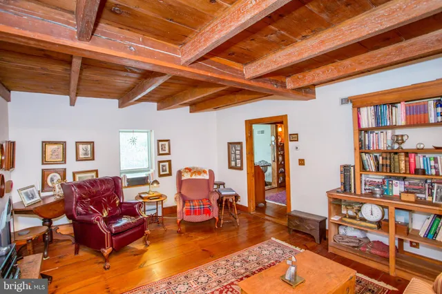 a view of living room with furniture and wooden floor