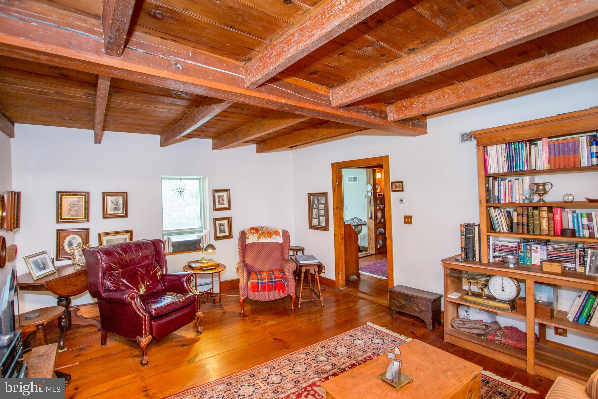 3416 Bursonville Road Riegelsville, PA 18077 - Photo 25 of 69 a living room with furniture a rug and a book shelf
