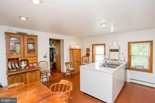 a bathroom with a sink mirror and tub
