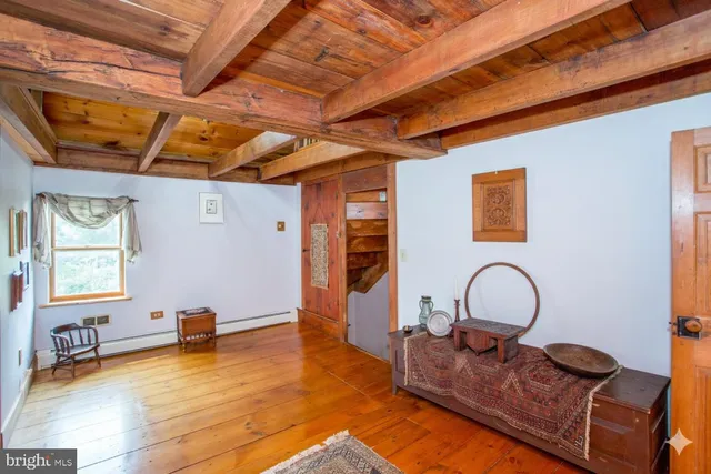 a living room with fireplace furniture and a book shelf