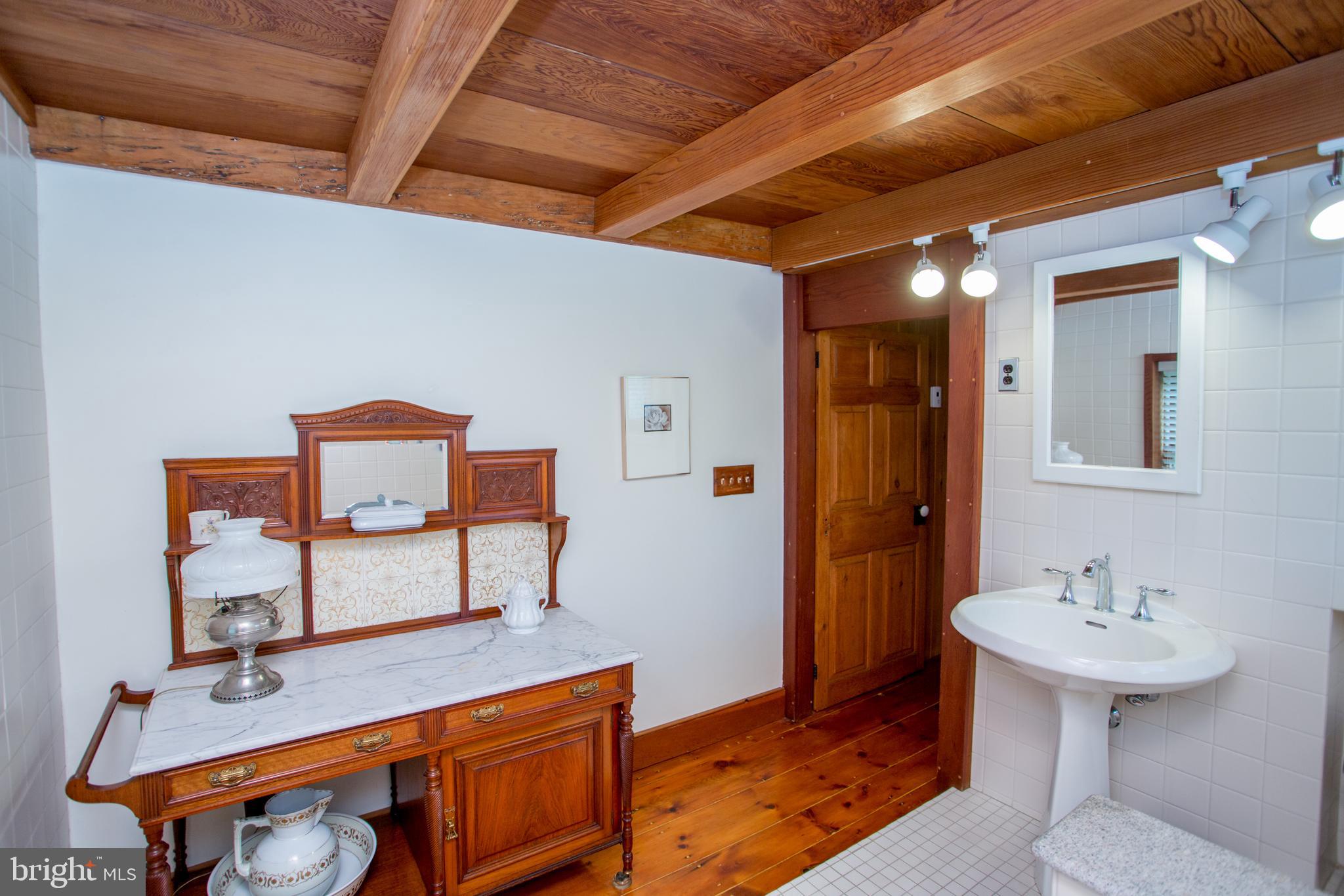 3416 Bursonville Road Riegelsville, PA 18077 - Photo 42 of 69 a bathroom with a sink mirror and tub