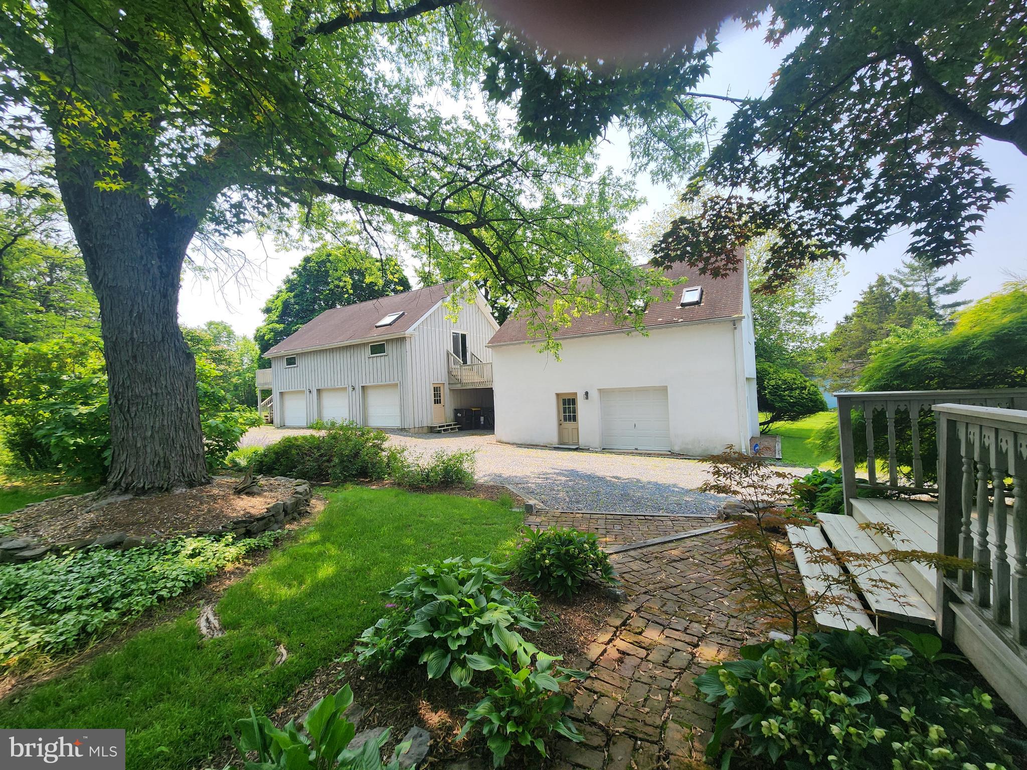 3416 Bursonville Road Riegelsville, PA 18077 - Photo 48 of 69 a backyard of a house with lawn chairs plants and tree