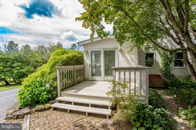 a view of a room that has a large window and front door