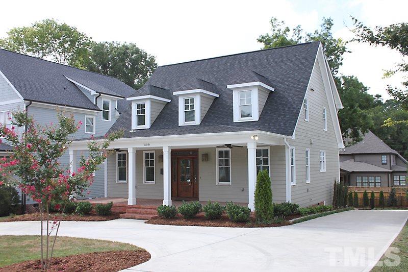 508 Mial Street Raleigh, NC 27608 - Photo 2 of 25 The home features a circular driveway plus a long driveway that leads to a huge parking pad area outside the fenced yard. Beautiful landscaping accents the drive and yard.