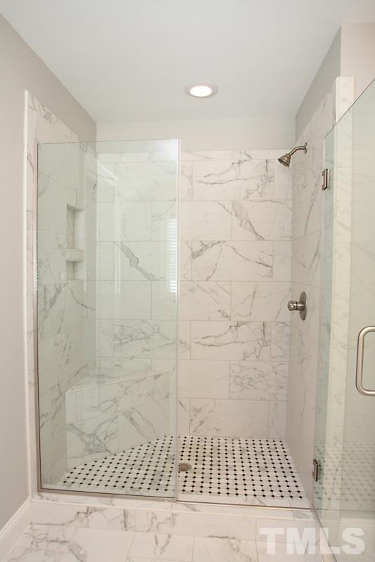508 Mial Street Raleigh, NC 27608 - Photo 16 of 25 The large master shower has a frameless glass surround and oversized tile.