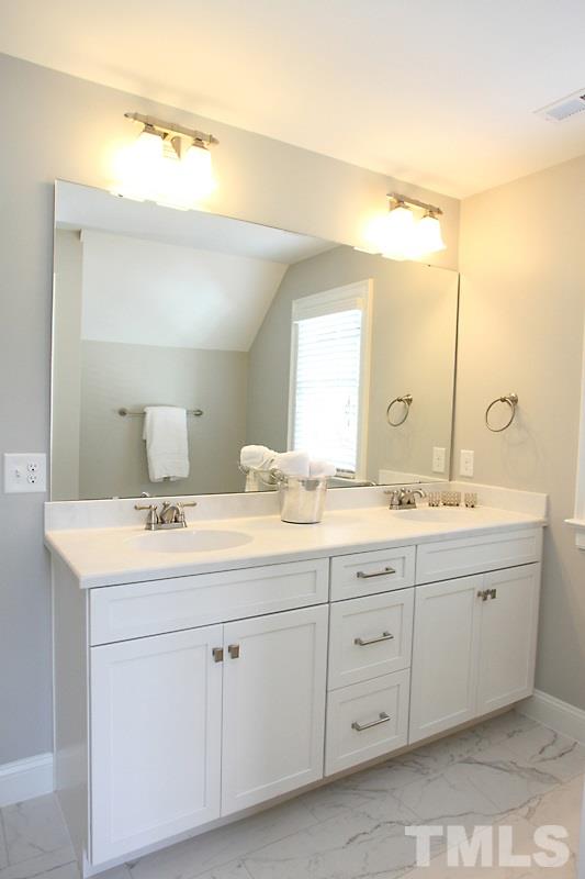 508 Mial Street Raleigh, NC 27608 - Photo 17 of 25 The master vanity has 2 sinks. The commode is in a private room.