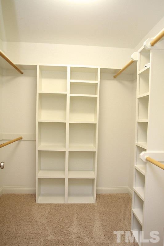 508 Mial Street Raleigh, NC 27608 - Photo 18 of 25 One of the 2 master closets with custom designed shelving layout.