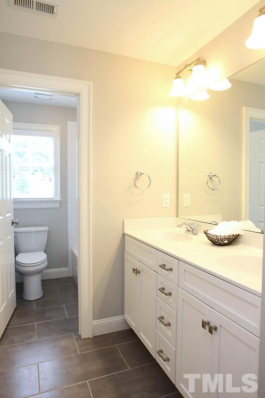 508 Mial Street Raleigh, NC 27608 - Photo 19 of 25 The upstairs hall bath has 2 sinks, comfort height vanity and the toilet and shower are in a separate room.