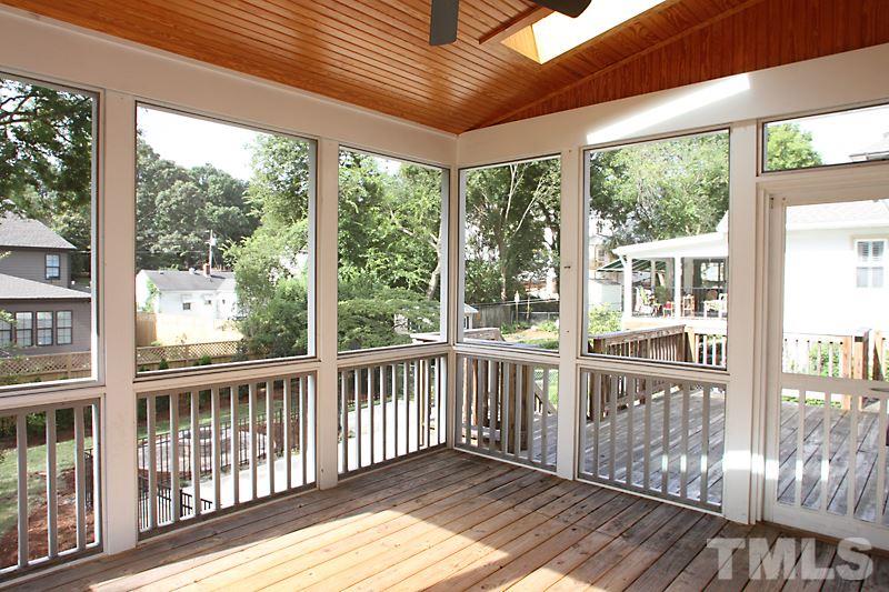 508 Mial Street Raleigh, NC 27608 - Photo 22 of 25 The screened porch with headboard ceiling and fan opens to the deck and overlooks the landscaped, fenced yard and parking area which can also serve as additional patio.