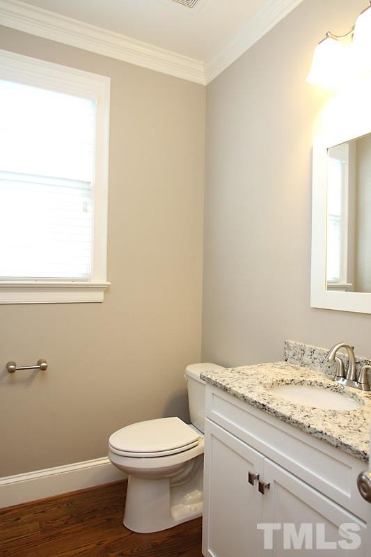 508 Mial Street Raleigh, NC 27608 - Photo 7 of 25 The first floor powder room has a vanity with granite countertop.
