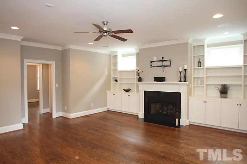 508 Mial Street Raleigh, NC 27608 - Photo 9 of 25 The hall from the family room leads to the powder room and connects to the living room.