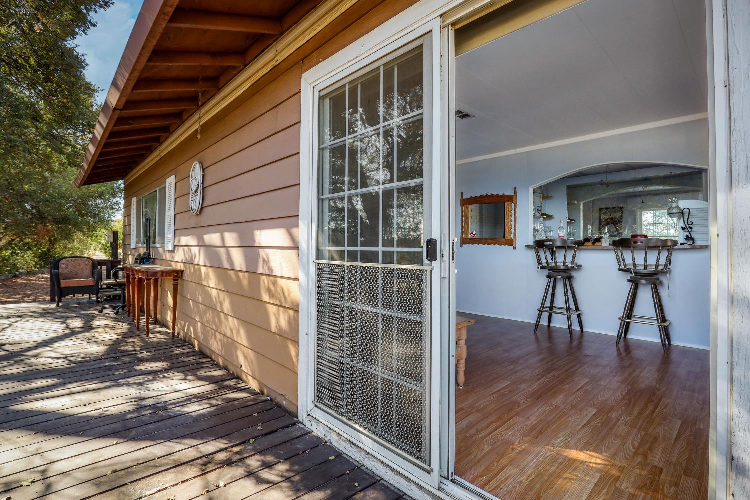 7080 Gwin Street Valley Springs, CA 95252 - Photo 13 of 96 a view of a porch with chairs and table of wooden floor