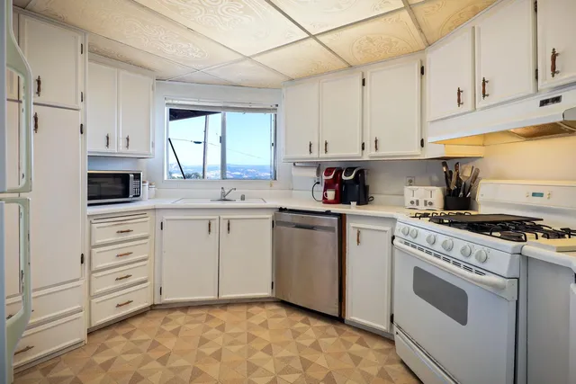a living room with furniture a dining table and chairs with wooden floor