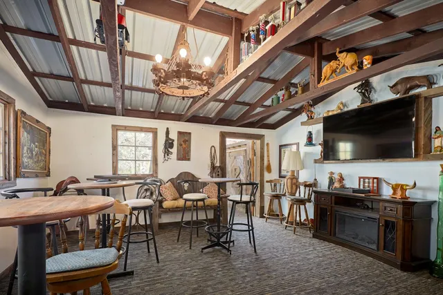 a view of house with yard and sitting area