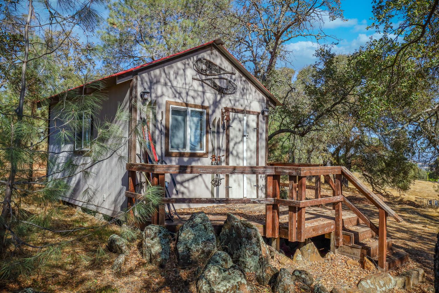 7080 Gwin Street Valley Springs, CA 95252 - Photo 47 of 96 a view of wooden house with large trees and wooden fence