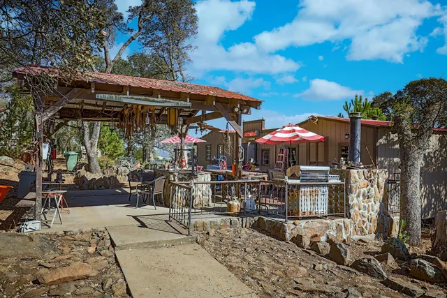a view of a patio with table and chairs with wooden floor and fence