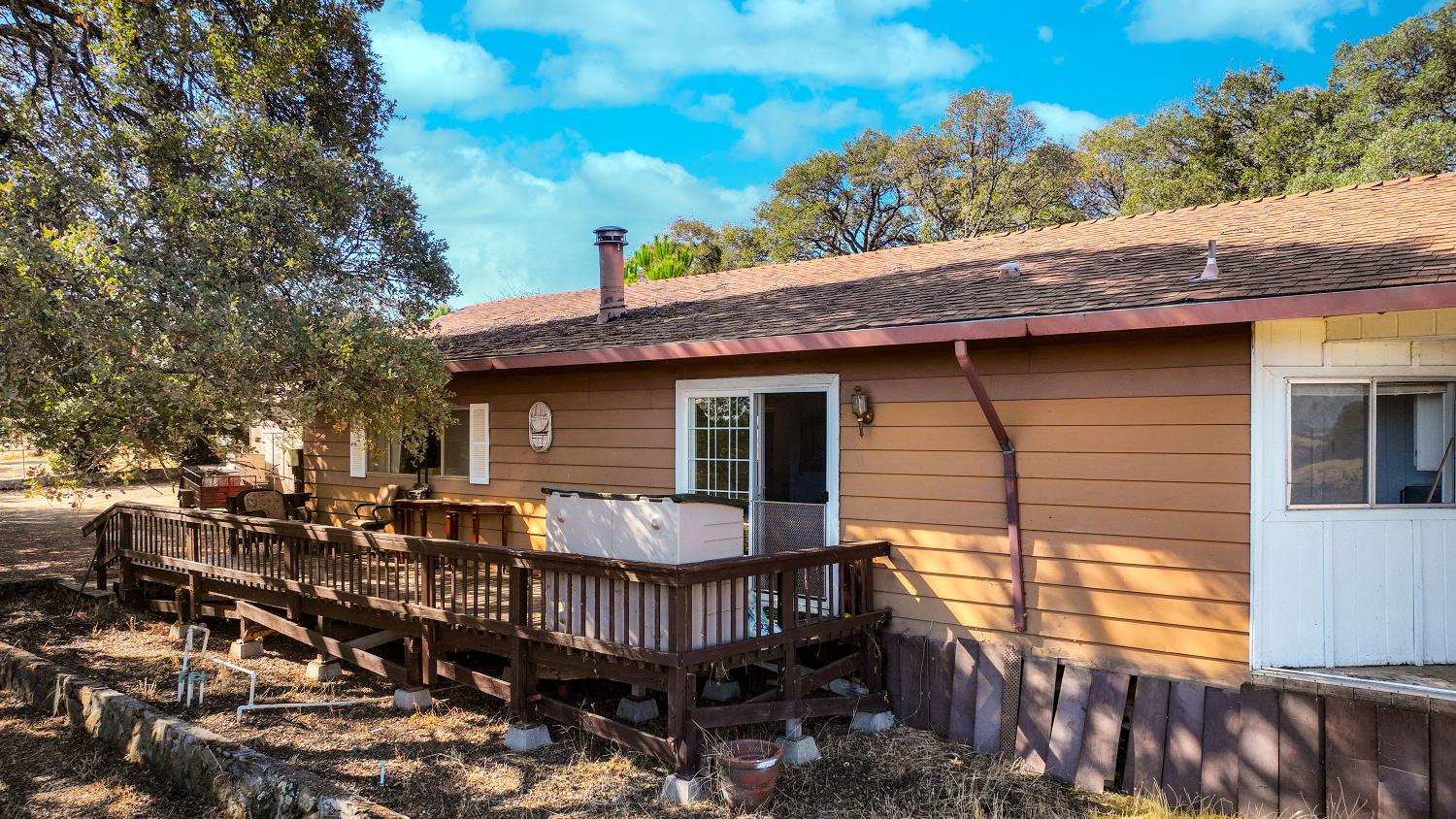 7080 Gwin Street Valley Springs, CA 95252 - Photo 90 of 96 a view of a wooden house with a chairs