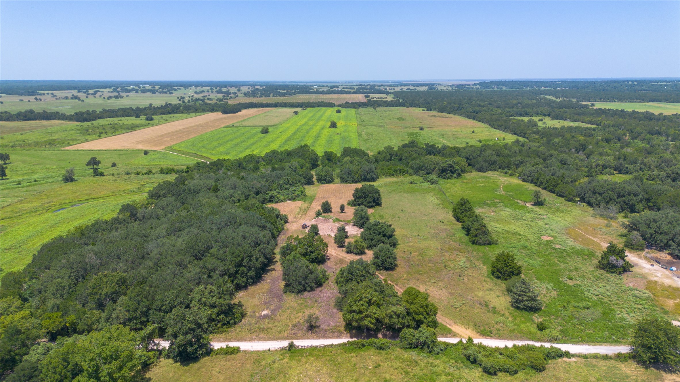 0 Devault Lane Brenham, TX 77833 - Photo 2 of 8 an aerial view of residential houses with outdoor space and swimming pool