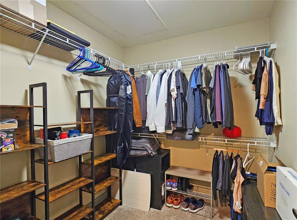 4561 Olde Perimeter Way, Unit 2407 Atlanta, GA 30346 - Photo 14 of 40 a view of walk in closet with clothes and shoes