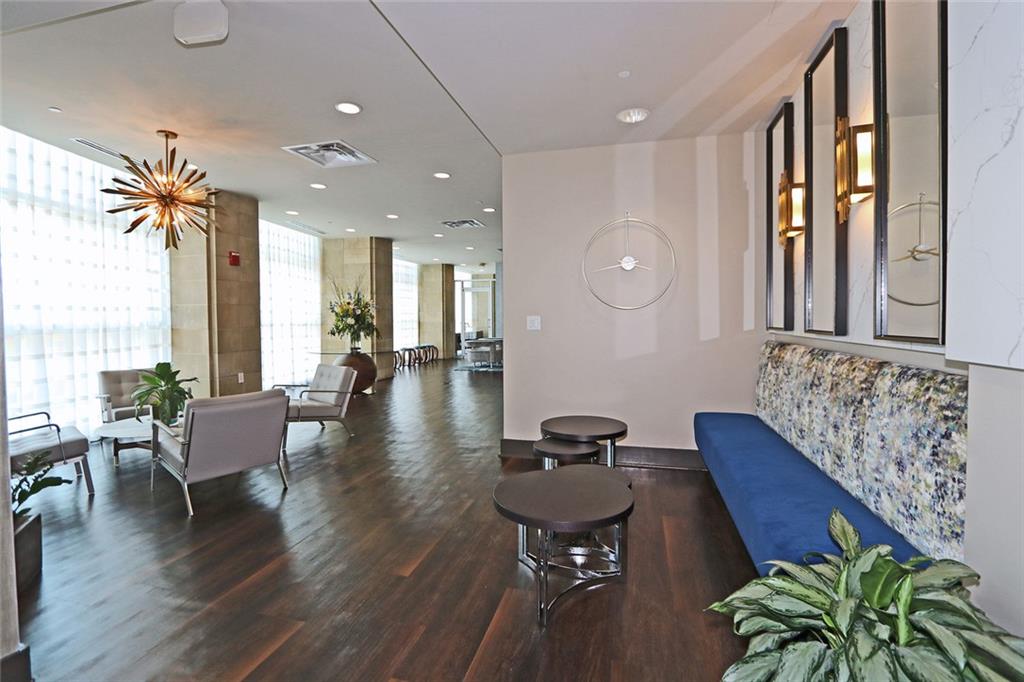 4561 Olde Perimeter Way, Unit 2407 Atlanta, GA 30346 - Photo 21 of 40 a living room with furniture and wooden floor