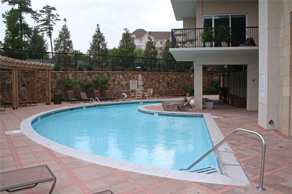 4561 Olde Perimeter Way, Unit 2407 Atlanta, GA 30346 - Photo 29 of 40 a view of a swimming pool with sitting area