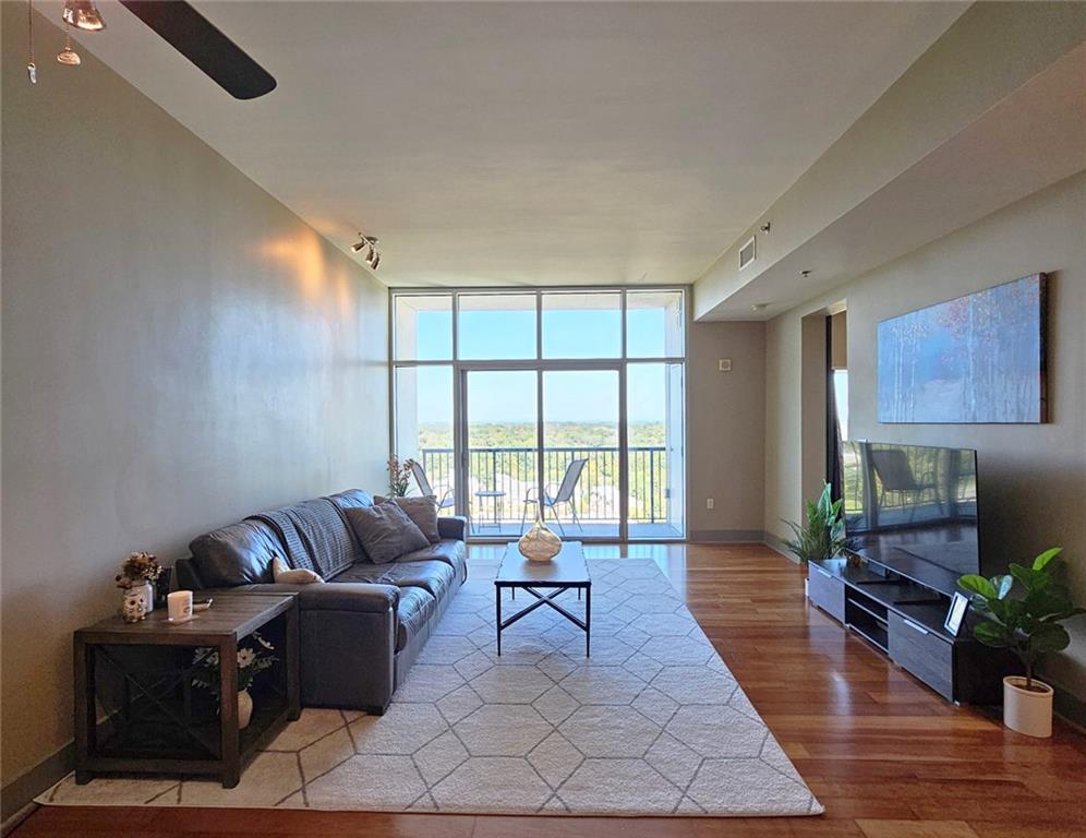 4561 Olde Perimeter Way, Unit 2407 Atlanta, GA 30346 - Photo 7 of 40 a living room with furniture and a large window