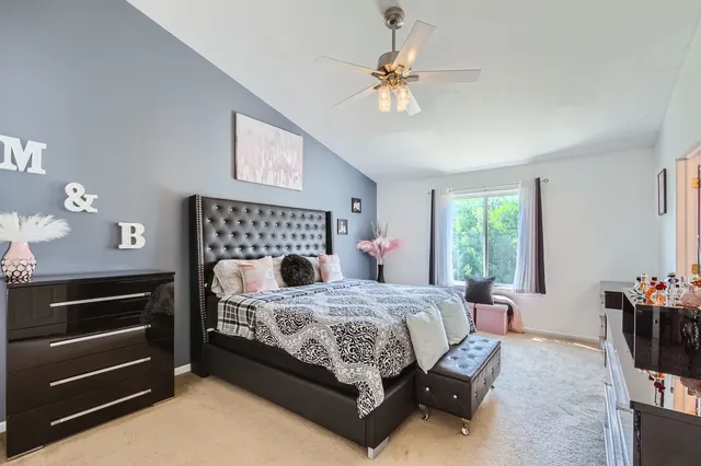 a bedroom with a bed and a chandelier