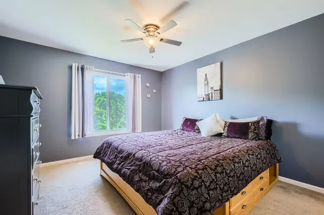 a bedroom with a large bed and a chandelier