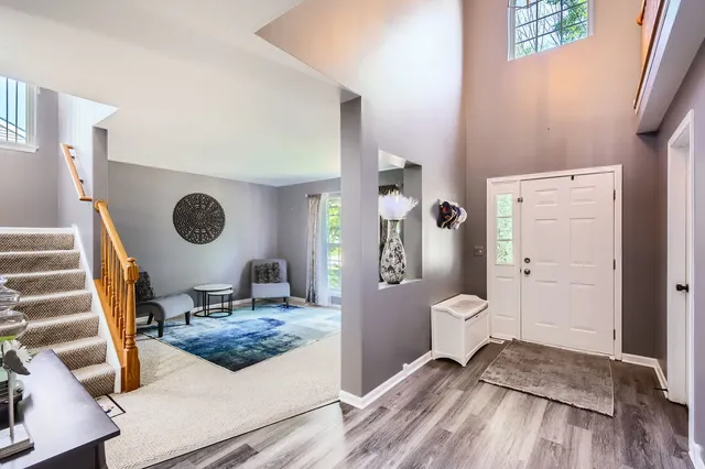 a living room with a bed and a wooden floor